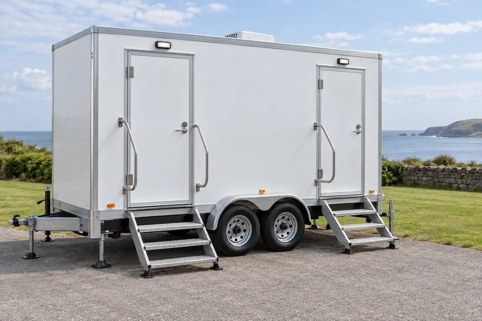 Restroom trailer with steps and handrails
